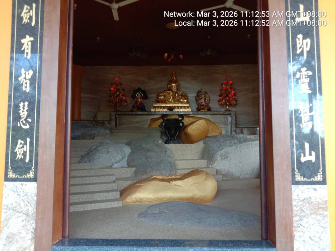 Buddhist temple inner shrine with a golden seated deity and rock garden, protected under KSD Security's temple guardian service.