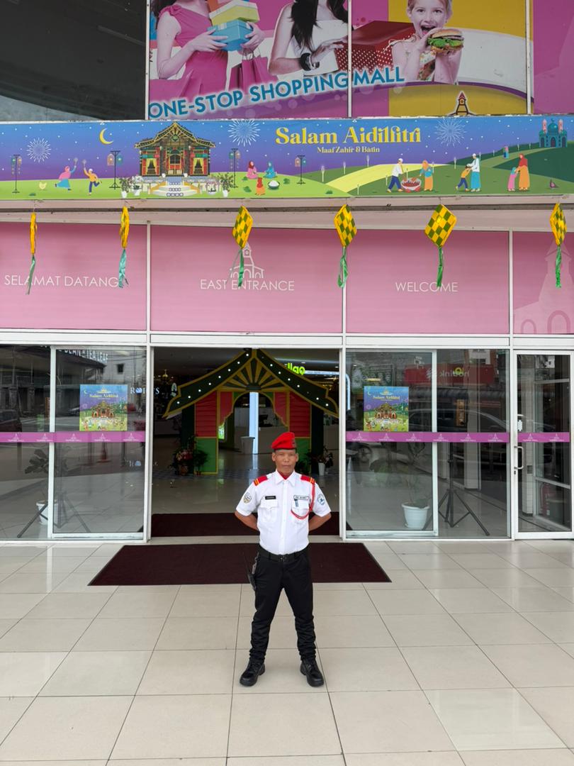 Uniformed KSD Security guard standing post at Taiping Mall shopping centre entrance