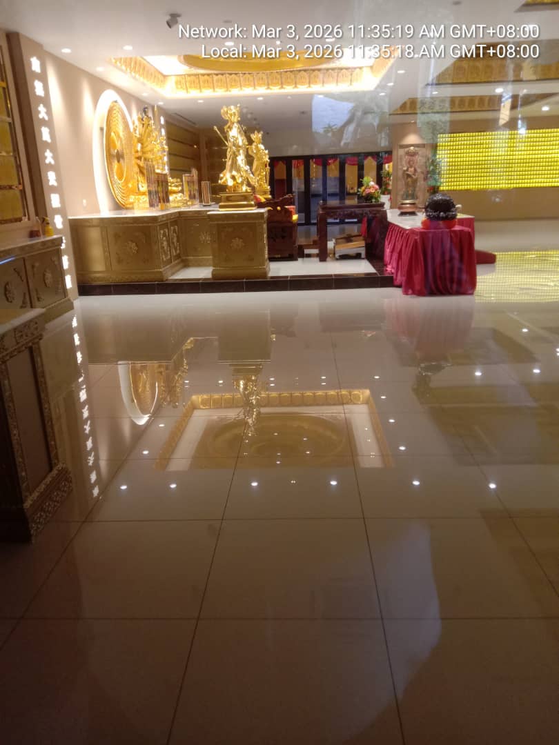 Grand golden prayer hall with deity statues and polished marble floor at a Buddhist temple protected by KSD Security's temple guardian service.